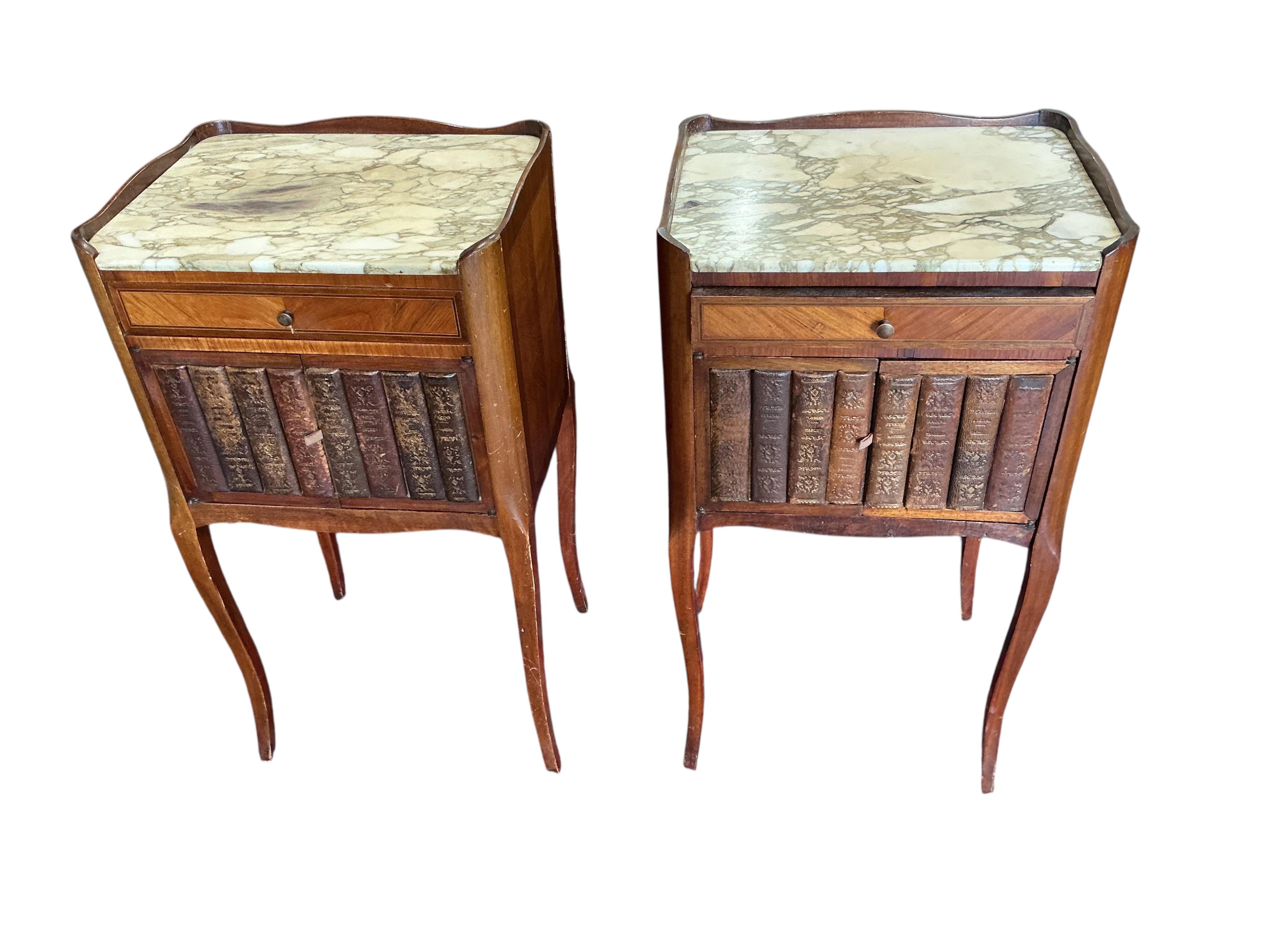 A pair of French marble topped kingswood bedside cabinets with faux book spine doors, width 39cm, depth 30cm, height 74cm